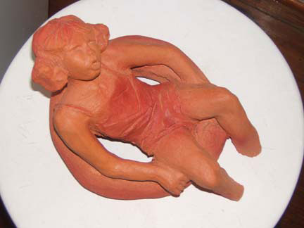 Sculpture Artwork by Pat Moberley Moore currently showing at The Water's Edge Studio and Gallery, Artwork is a terracotta sculpture titled 'Floating', 5 inches high; Contact thewatersedge at houston dot rr dot com for more information